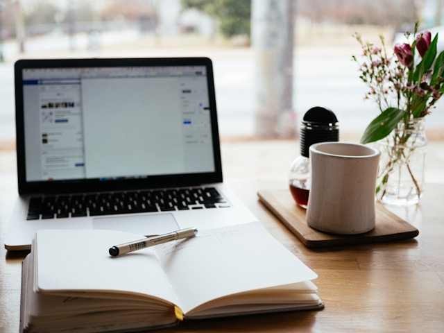 Laptop and notebook representing online learning resources and digital study tools